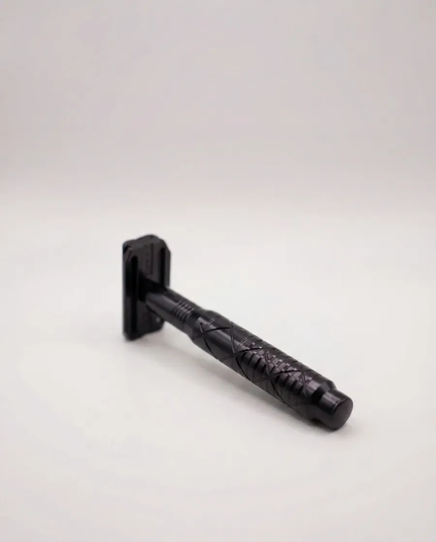 The Tier One Echelon safety razor in a stealth black anodized finish, photographed on a soft white background