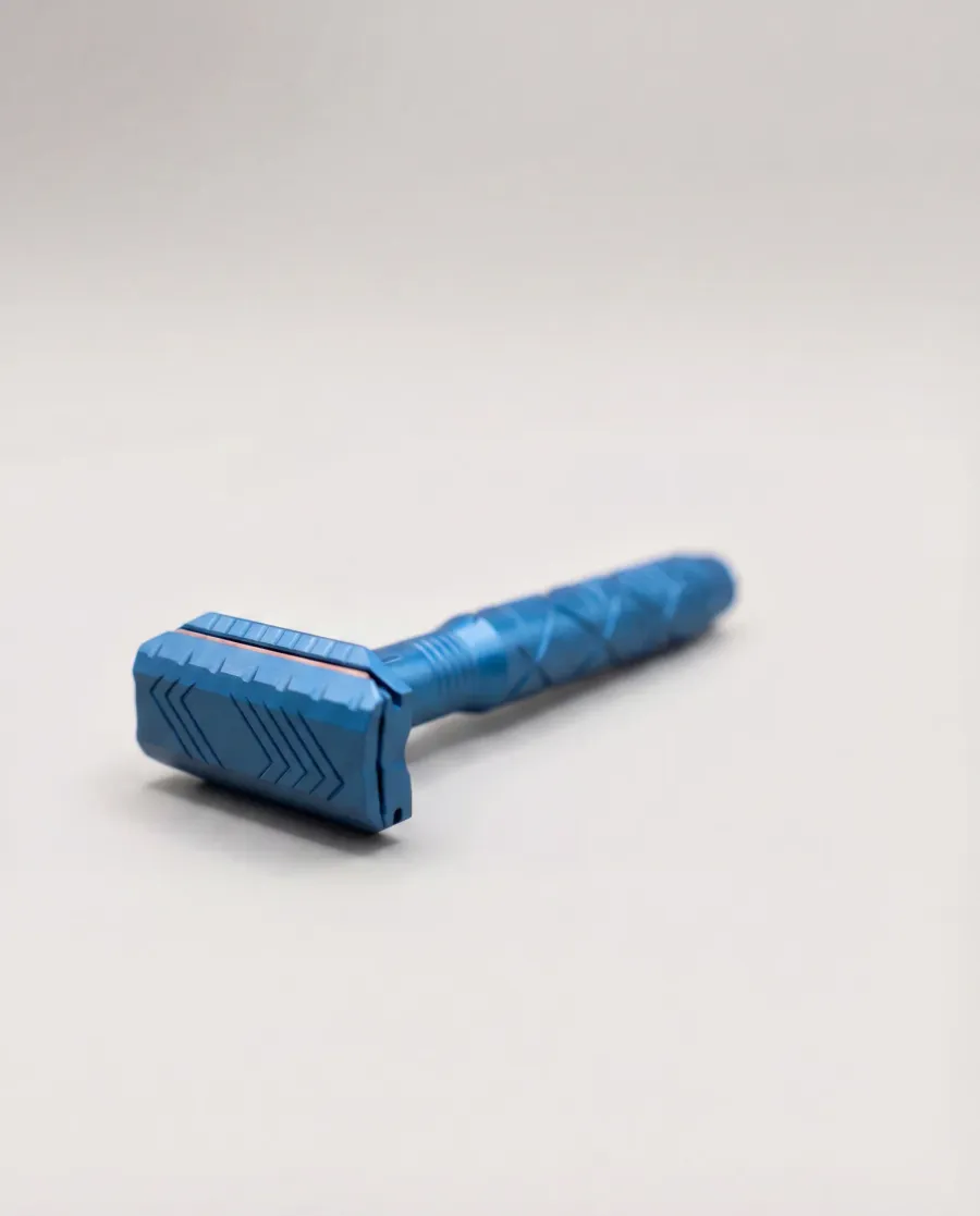 The Tier One Echelon safety razor in a cobalt blue anodized finish, photographed on a soft white background