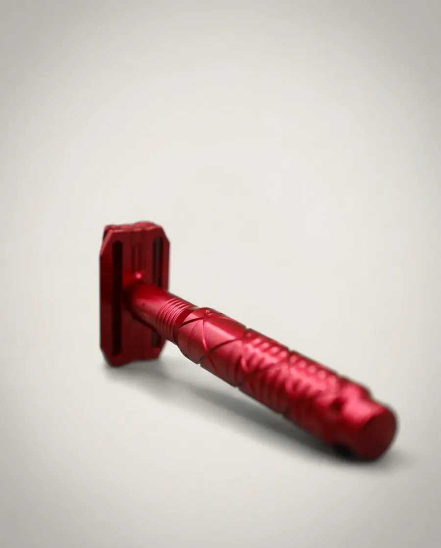 The Tier One Echelon safety razor in a deep red anodized finish, photographed on a soft white background