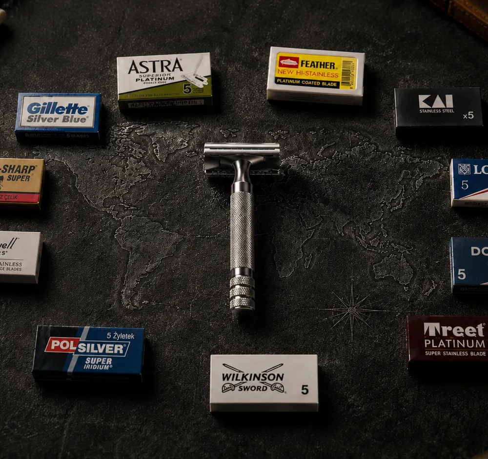 A vintage DE safety razor centered on a world map surrounded by blade packs from Astra, Feather, Kai, Gillette Silver Blue, Lord, Dorco, Perma-Sharp, Polsilver, Rockwell, Treet, and Wilkinson Sword