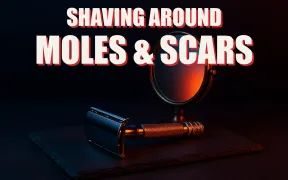 A safety razor resting beside a small hand mirror on dark slate under dramatic split lighting, headline SHAVING AROUND MOLES AND SCARS in white block letters with a red drop shadow