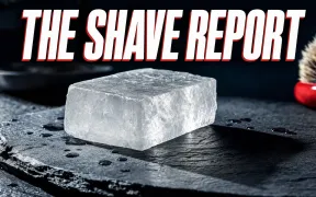 A cinematic close-up of a translucent white crystalline alum block on a dark slate counter, catching hard side light with subtle internal facets and a few water droplets around it, headline THE SHAVE REPORT in white block letters with a red drop shadow across the top