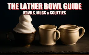A ceramic lather bowl with a mound of white lather, a coffee mug, and a double-walled scuttle in a row on dark slate under warm light, headline THE LATHER BOWL GUIDE in white block letters with a red drop shadow