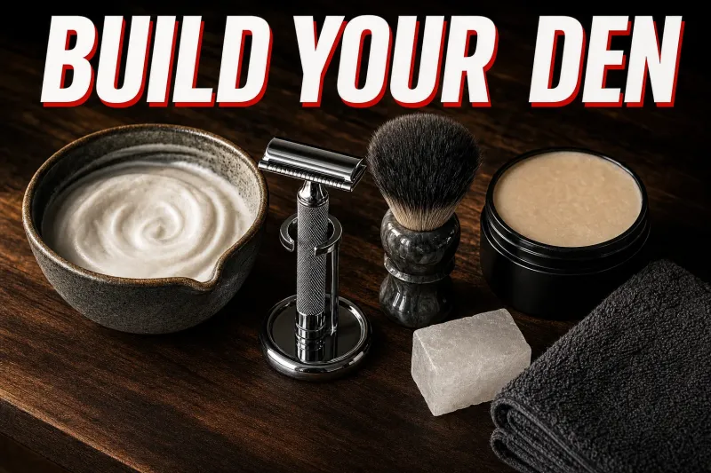 An overhead flatlay on dark walnut of a wet shaving station, a chrome safety razor resting on a stand, a shaving brush drying beside a ceramic lather bowl, a soap puck, an alum block and a folded towel under warm side light, headline BUILD YOUR DEN in white block letters with a red drop shadow across the top