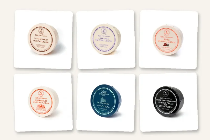 Six Taylor of Old Bond Street shaving cream bowls: Sandalwood, Lavender, Rose, and Grapefruit in ivory, the blue Eton College bowl, and the black Jermyn Street sensitive skin bowl.