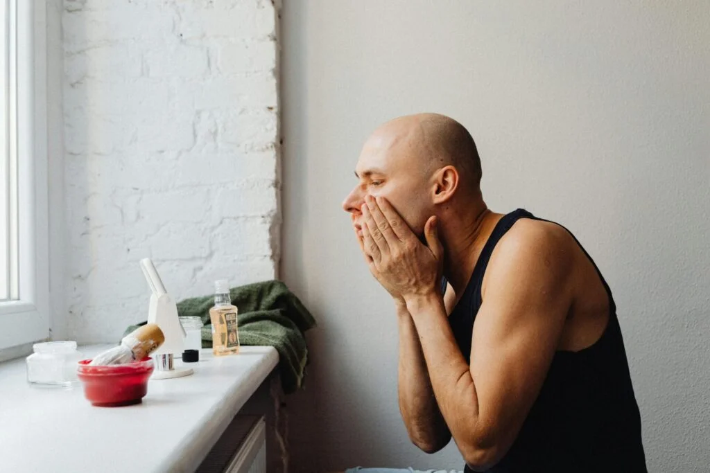 Man grooming his face